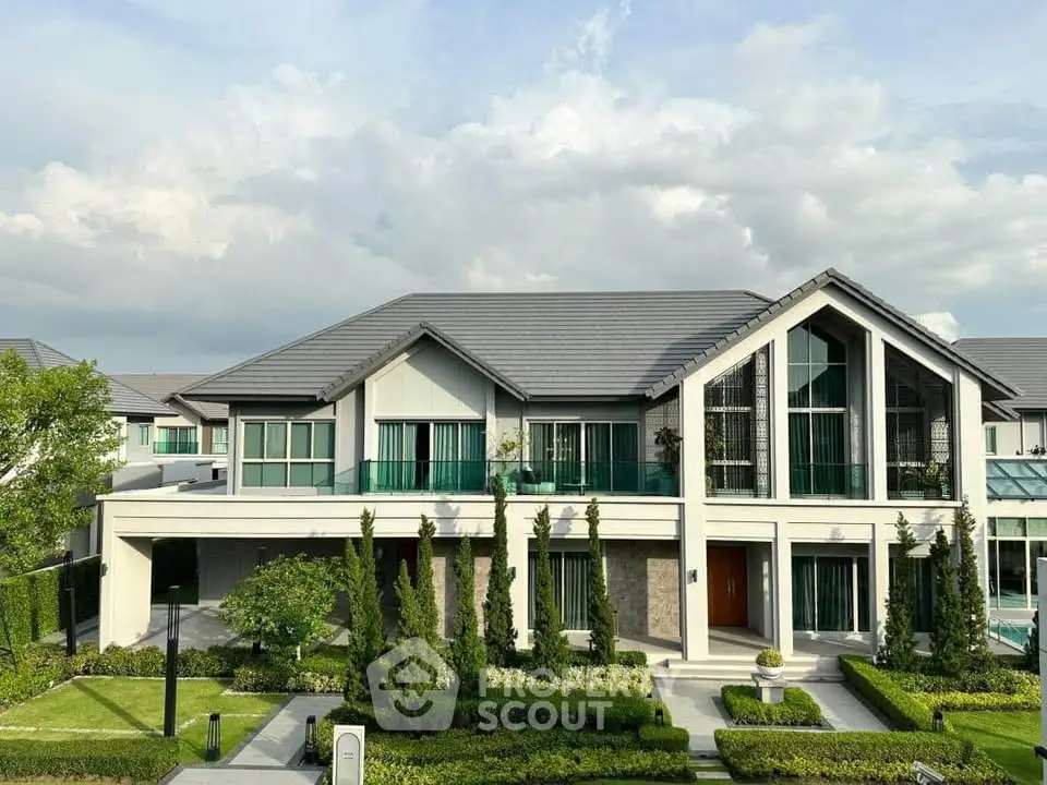 Stunning modern house with lush garden and large windows, perfect for luxury living.