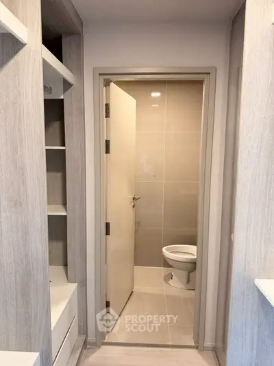 Modern bathroom entrance with sleek design and neutral tones