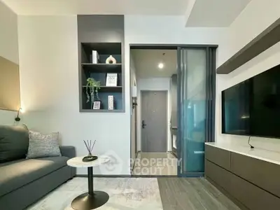 Modern living room with sleek design, featuring a cozy sofa, wall-mounted TV, and stylish decor.