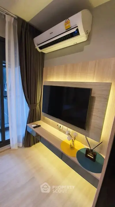 Modern living room with wall-mounted TV and air conditioning unit