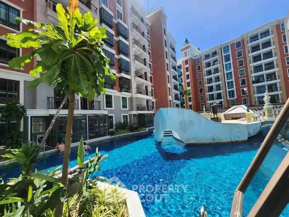 Luxurious apartment complex with stunning pool and lush greenery