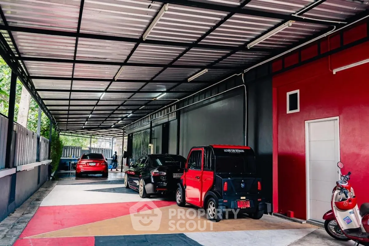 Spacious covered parking area with modern design and multiple vehicles parked.