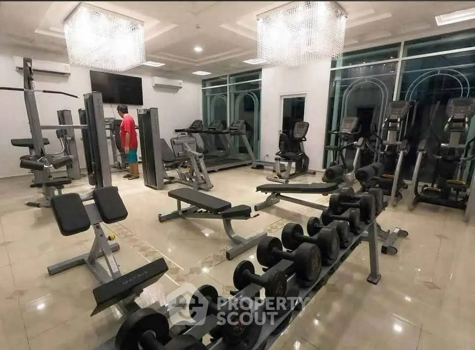Modern gym with state-of-the-art equipment in luxury residential building.