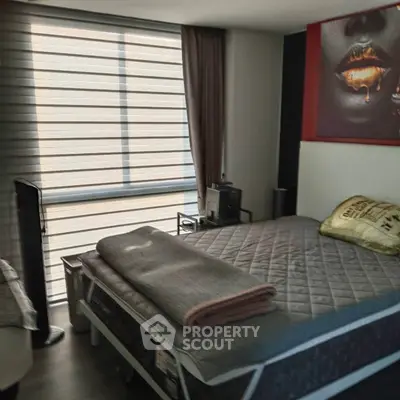 Cozy bedroom with modern decor and large window for natural light