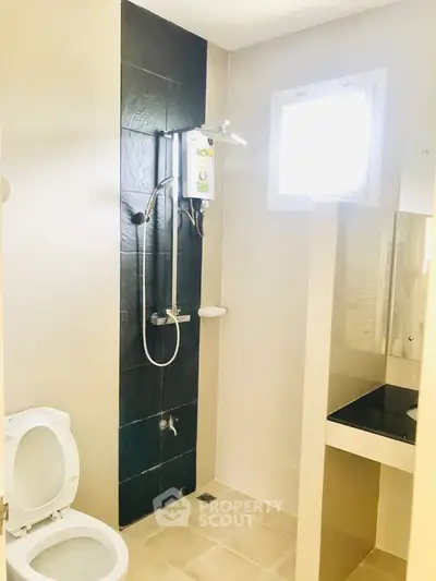 Modern bathroom with sleek shower and natural light from window