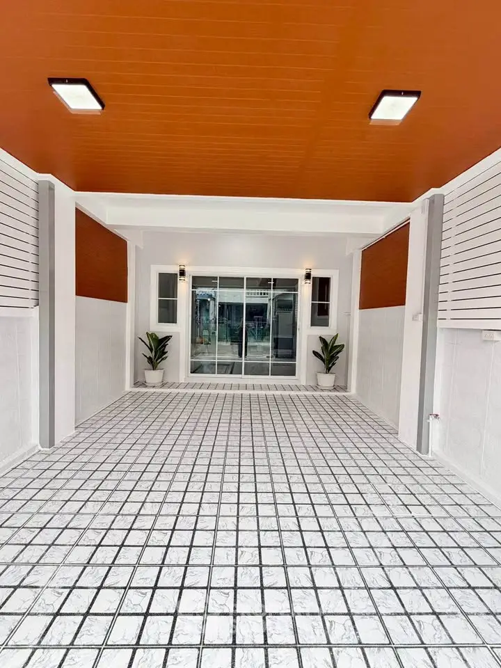 Spacious modern garage with tiled flooring and sleek lighting, perfect for secure parking or versatile use.