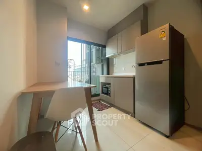 Modern kitchen with sleek appliances and dining area in a stylish apartment