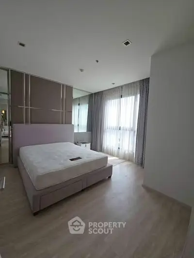 Spacious modern bedroom with large windows and minimalist design