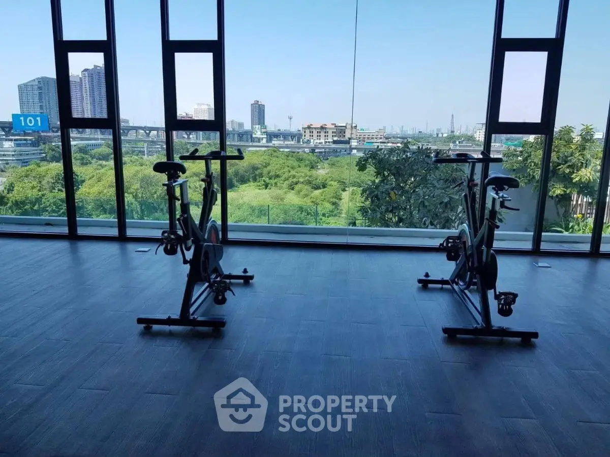Modern gym with exercise bikes and panoramic city view