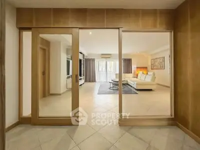Spacious living room with modern decor and large windows for natural light.