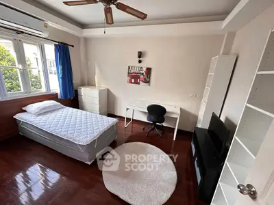 Spacious bedroom with modern furniture and natural light