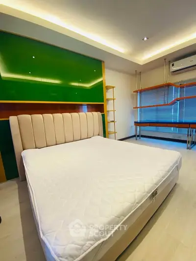 Modern bedroom with stylish bed and built-in shelves, featuring sleek design and ambient lighting.