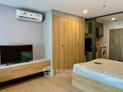 Modern bedroom with built-in wardrobe and air conditioning in a stylish apartment.