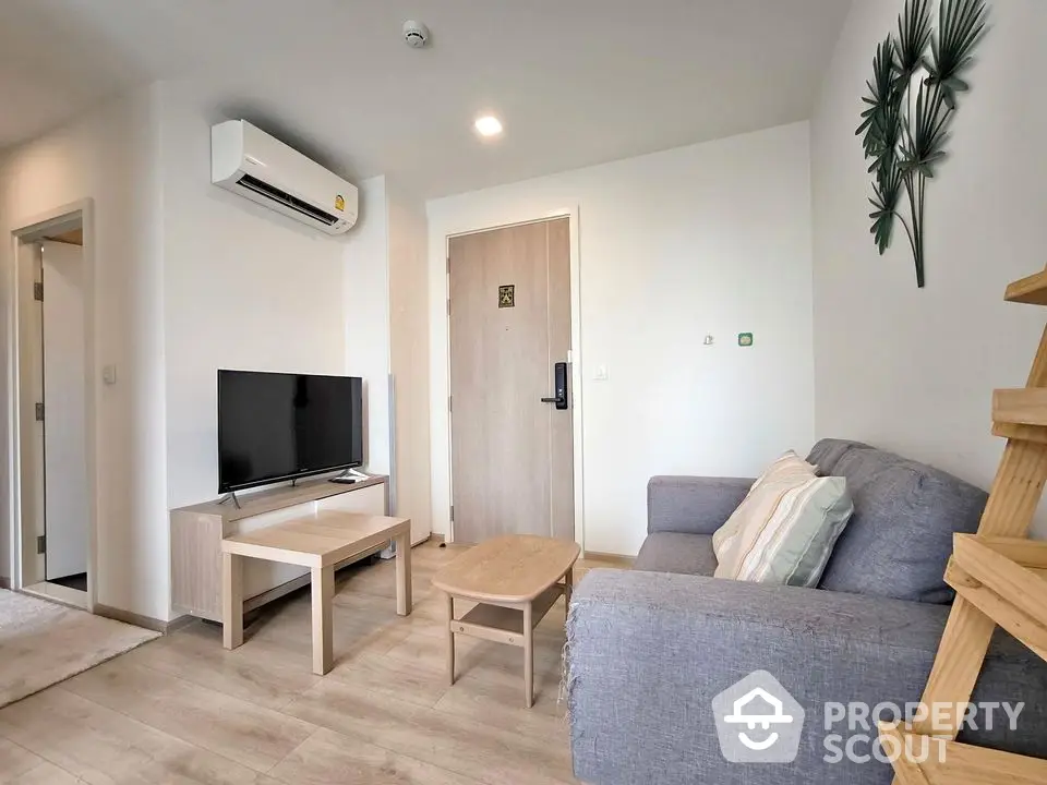 Modern living room with cozy sofa, TV, and air conditioning in a stylish apartment.