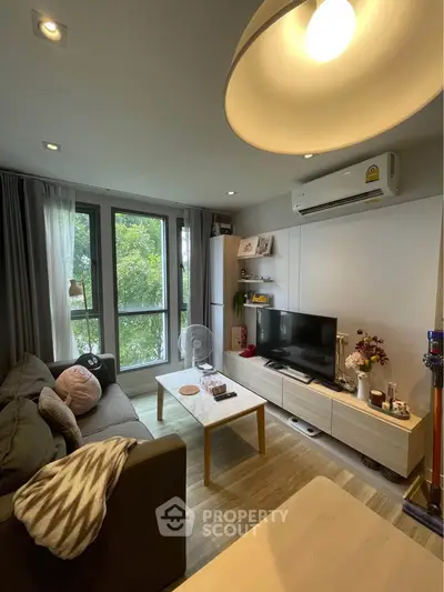 Cozy living room with modern decor and large window view