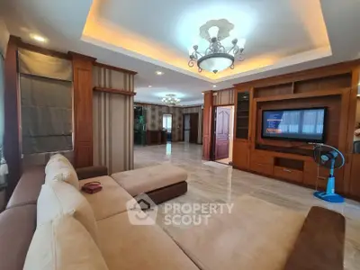 Spacious living room with elegant lighting and modern furnishings in a luxurious home.