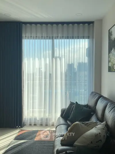 Cozy living room with leather sofa and large window with city view