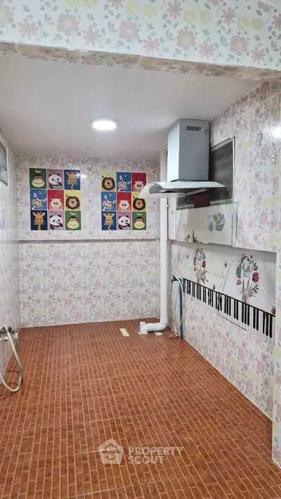 Charming kitchen with floral wallpaper and unique tile design, perfect for a cozy home atmosphere.