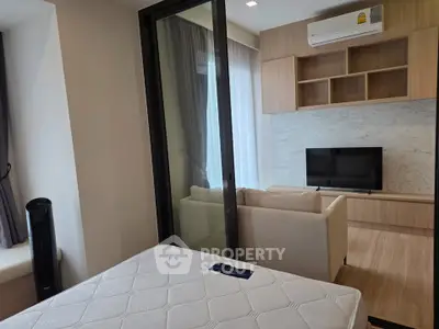 Modern apartment interior with cozy living room and bedroom, featuring sleek design and natural light.
