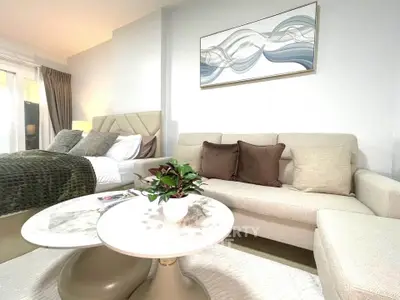 Elegant bedroom with cozy seating area and modern decor