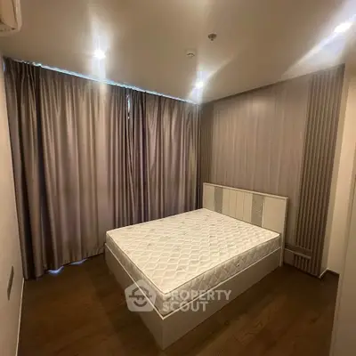 Modern bedroom with sleek design and cozy ambiance, featuring a stylish bed and elegant curtains.