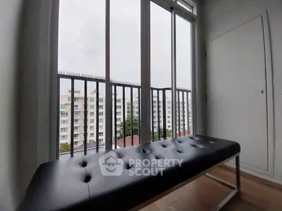 Modern apartment balcony with sleek bench and city view