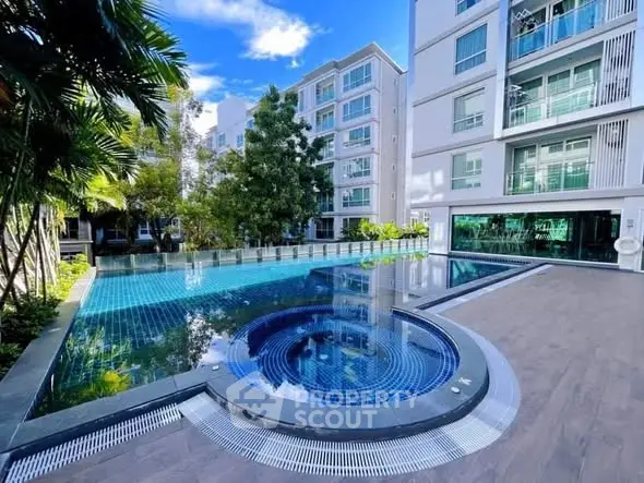 Luxurious apartment complex with stunning pool and modern architecture