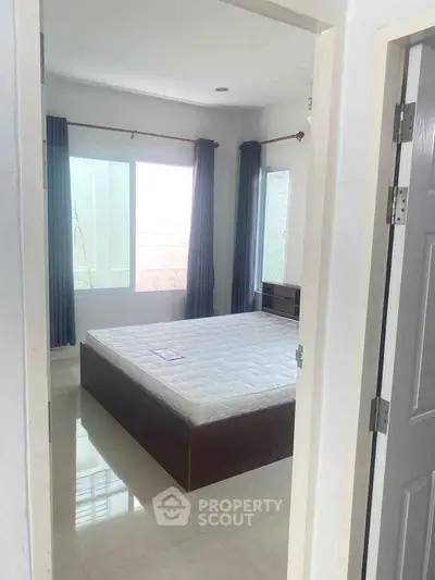 Bright and airy bedroom with large windows and minimalist decor