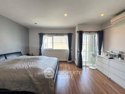 Spacious bedroom with modern decor and natural light