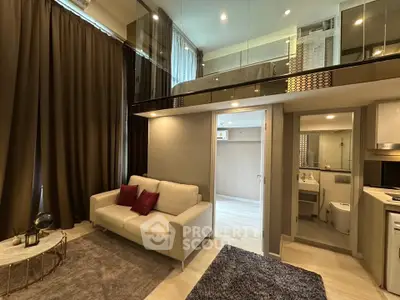 Modern loft apartment with stylish living room and mezzanine bedroom, featuring elegant decor and ample natural light.