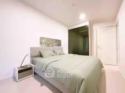 Modern minimalist bedroom with sleek design and neutral tones, featuring a comfortable bed and stylish decor.