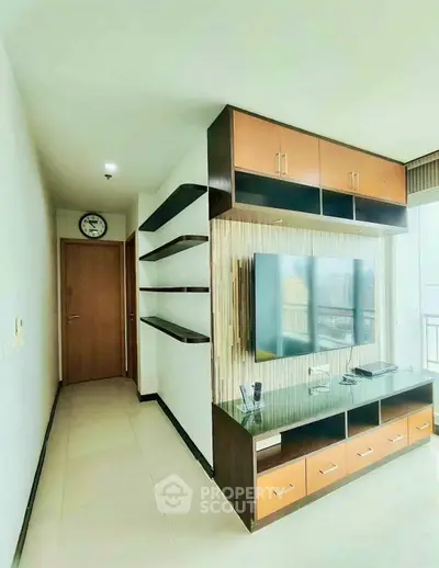 Modern living room with sleek TV unit and open shelves, featuring a bright and airy ambiance.