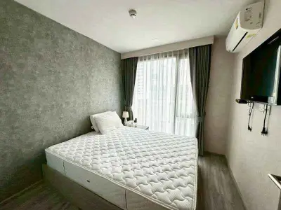 Modern bedroom with stylish decor and natural light in a contemporary apartment.