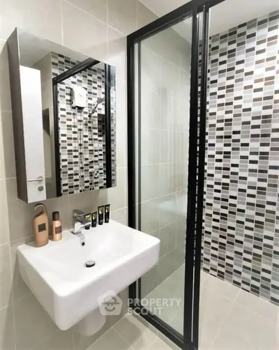 Modern bathroom with stylish tiles and sleek glass shower door