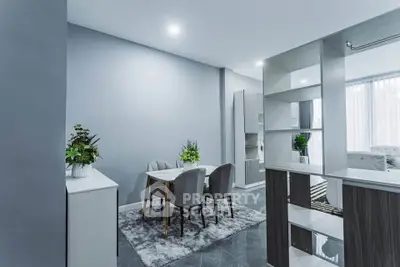 Modern open-plan living and dining area with stylish decor and ample natural light.