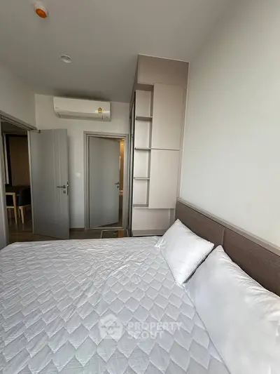 Modern bedroom with stylish decor and air conditioning in a contemporary apartment.