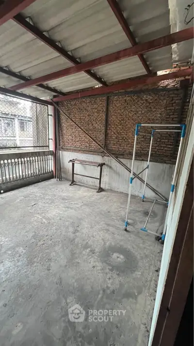 Spacious covered balcony with potential for customization in urban setting.