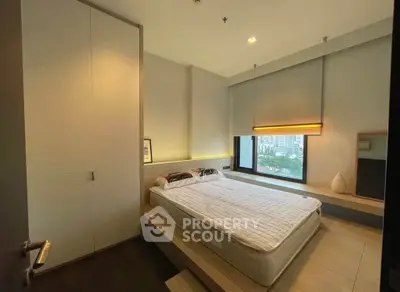 Modern bedroom with large window and minimalist design in urban apartment