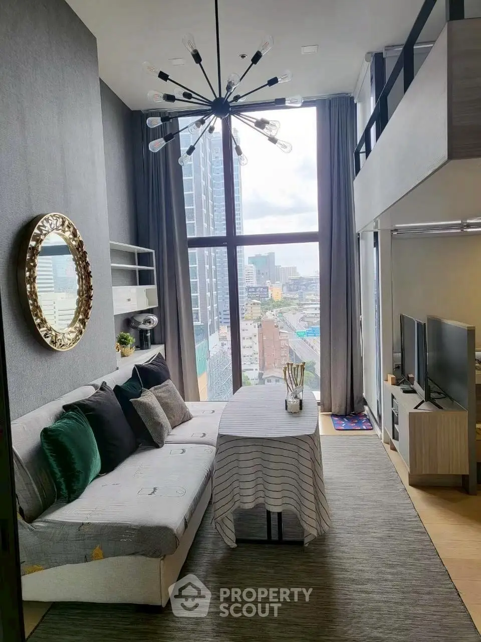 Modern loft-style living room with high ceilings and city view