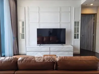 Modern living room with sleek TV setup and elegant paneling