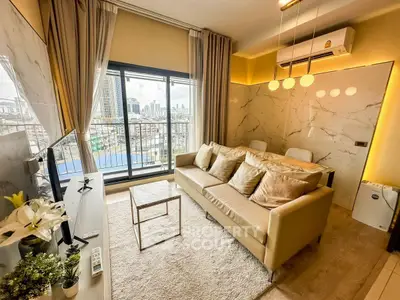 Modern living room with city view, stylish decor, and cozy seating area.