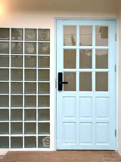 Charming light blue door with glass block wall, perfect for modern home entryway.