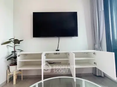 Modern living room with wall-mounted TV and open white cabinet