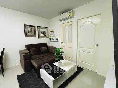 Modern living room with stylish sofa and wall art in a cozy apartment.
