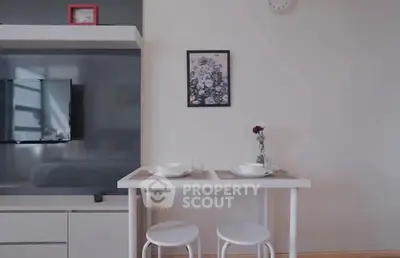 Modern living room with stylish dining area and wall-mounted TV