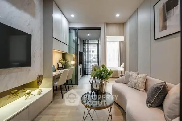 Modern living room with stylish decor and open layout, featuring a cozy seating area and workspace.