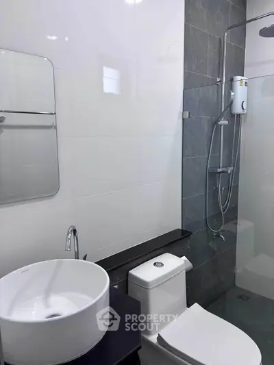 Modern bathroom with sleek fixtures and glass shower enclosure