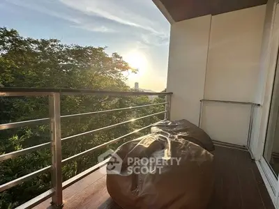 Charming balcony with stunning sunset view and cozy seating area.