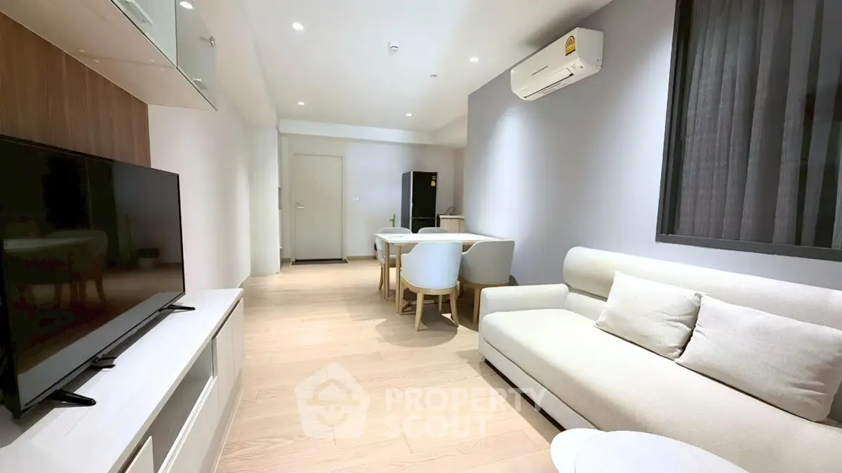 Modern living room with sleek furniture and air conditioning in a stylish apartment.