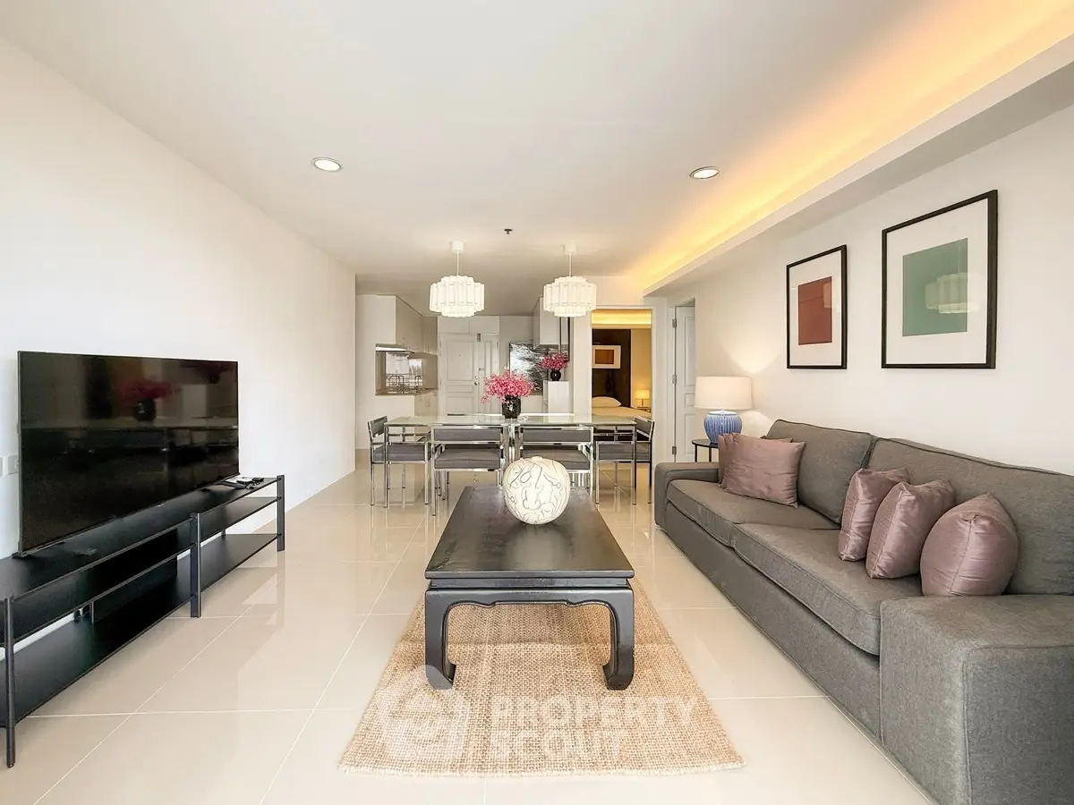 Spacious modern living room with elegant decor and ample natural light.